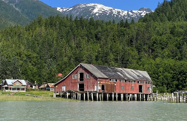 The Tallheo Cannery with the snow-capped mountains in the background #olafincanada #britishcolumbia #discoverbc #abandonedbc #tallheocannery #bellacoola